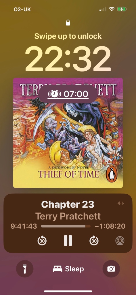 Screenshot of my  Locked Screen at 22:32 as I listened to The Thief Of Time a recent update means the cover picture appears on screen.